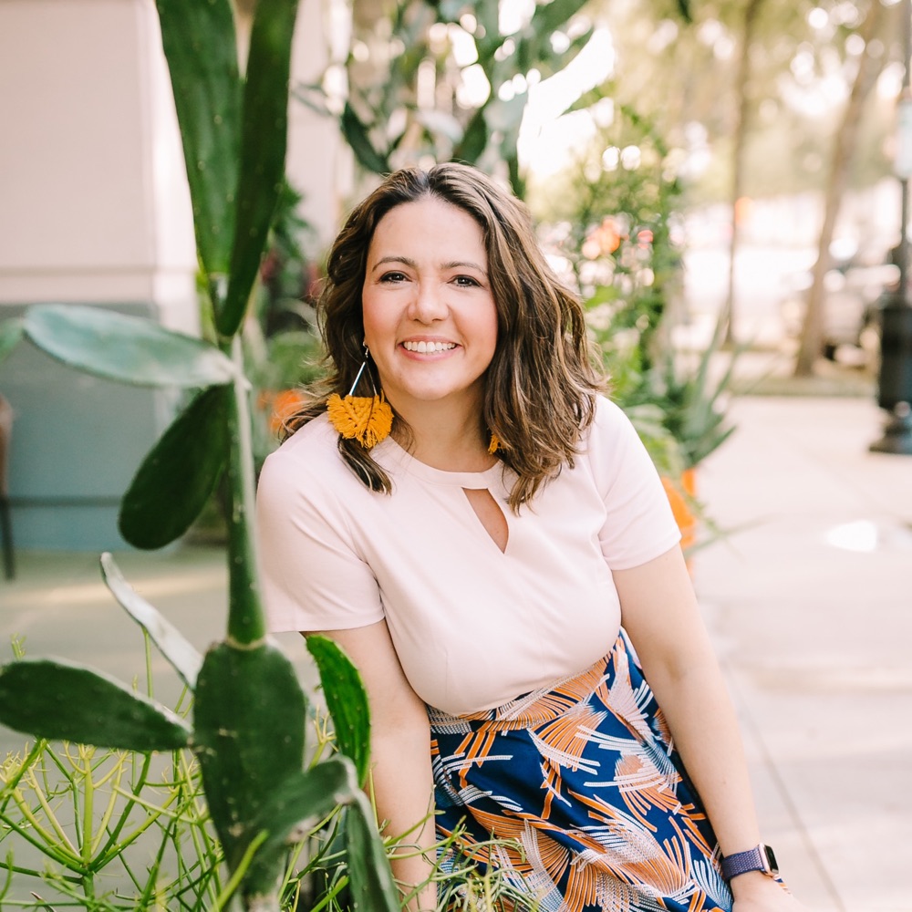 Renee Seltzer, founder of Grit & Agency, smiling on a sidewalk in Orlando